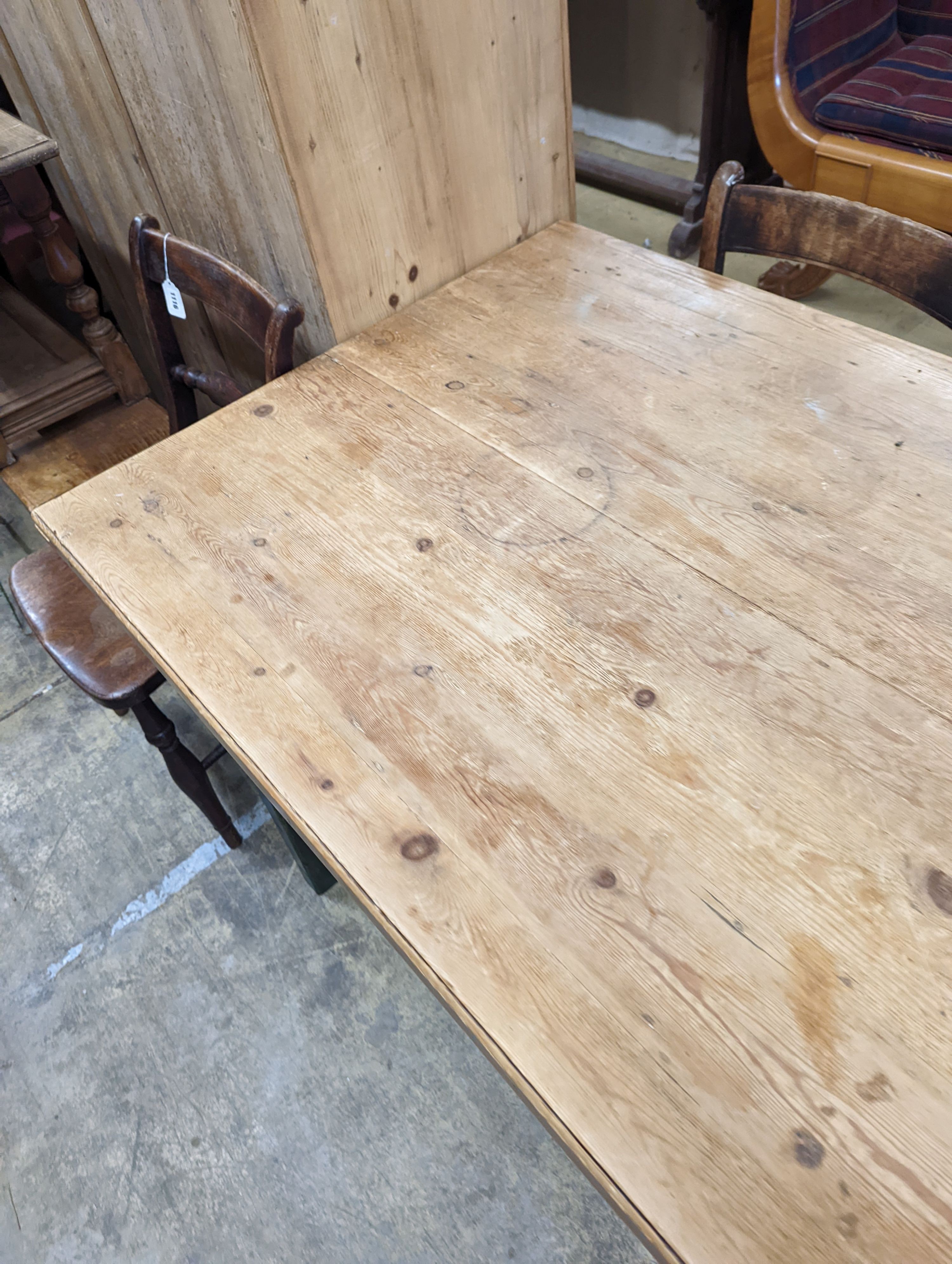 A rustic farmhouse pine kitchen table with painted legs, length 192cm, depth 85cm, height 76cm